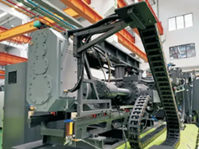 Large helical gearboxes for injection molding machines